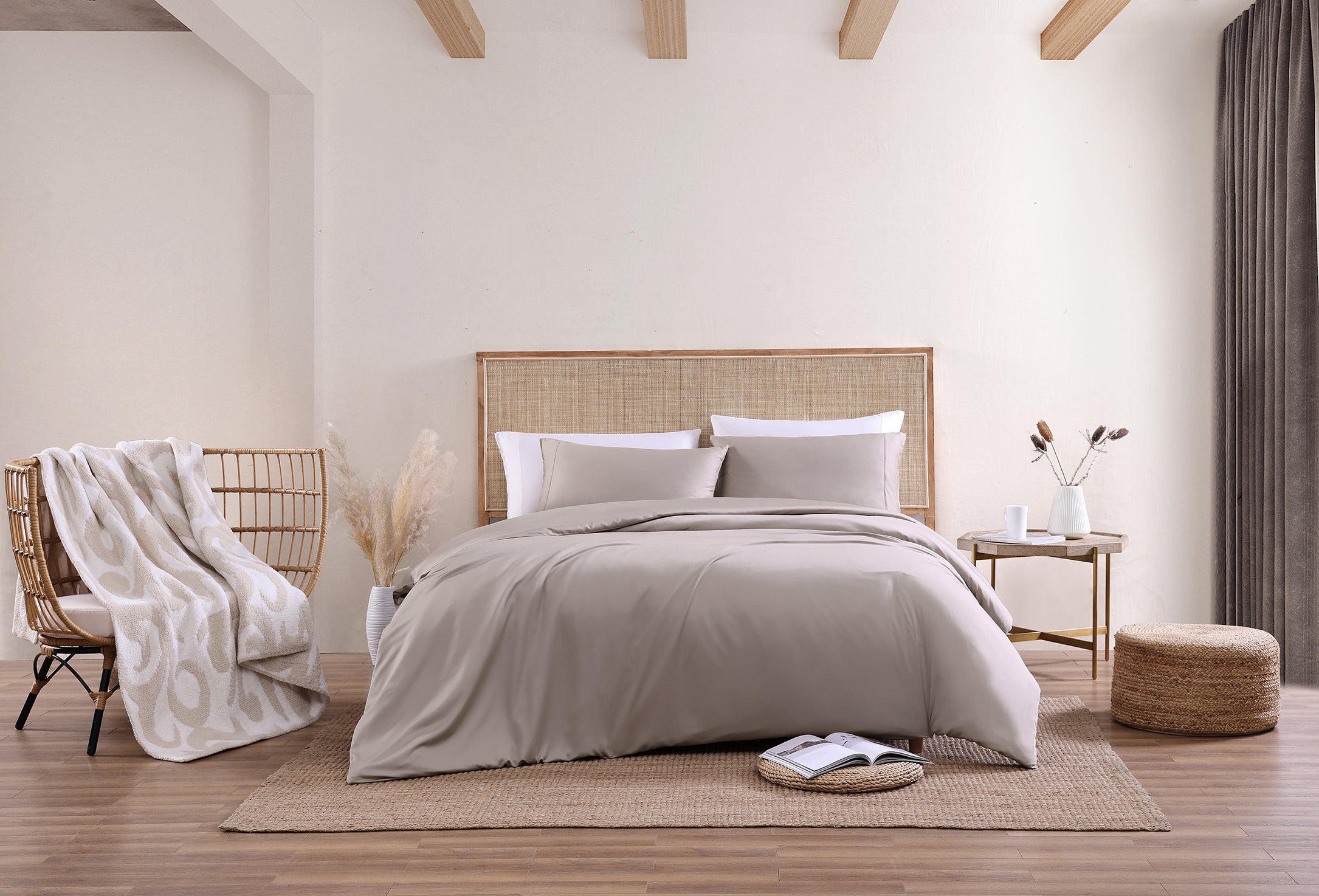 Sunday Citizen's Premium Bamboo Duvet Cover in Taupe and Premium Bamboo Sham Set in Taupe. Taupe colored bedroom. Tan decorated bedroom. Casablanca Throw in Sahara Tan laying on a chair. 