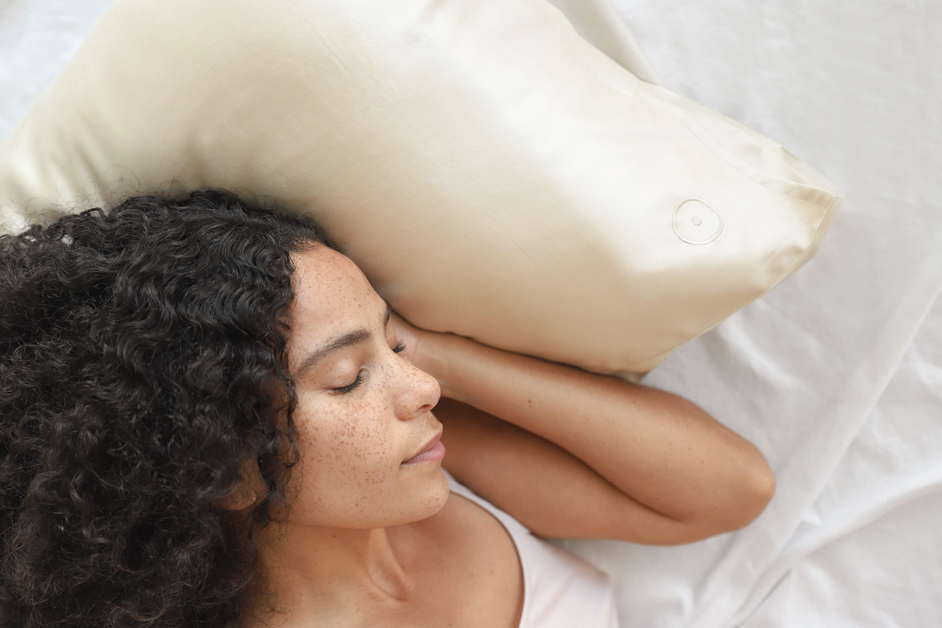 Woman resting head on silk pillowcase. Sunday Citizen Washable Silk Pillowcase.