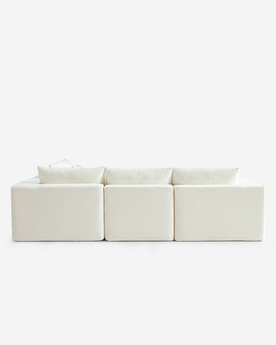 Sectional cream sofa from three-seat configuration with cushions and matching fabric
