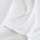 Sunday Citizen Muslin Throw in White close-up of soft fabric texture